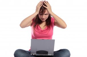 stressed person sitting with laptop